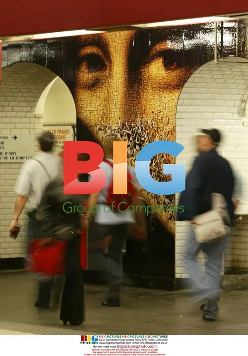 Commuters Pass Paris Metro with Da Vinci Code Decor