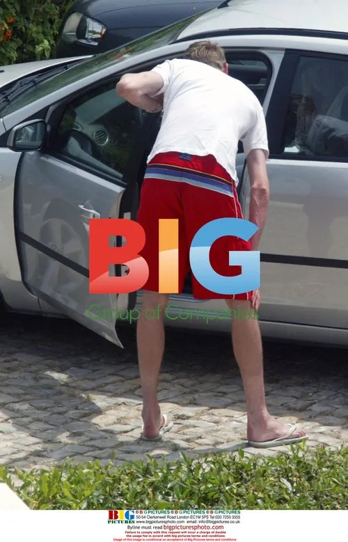 Tall England footballer Peter Crouch squeezes into car