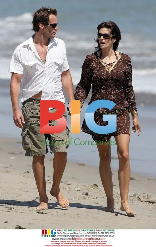 Cindy Crawford and Randy Gerber walk on Malibu beach