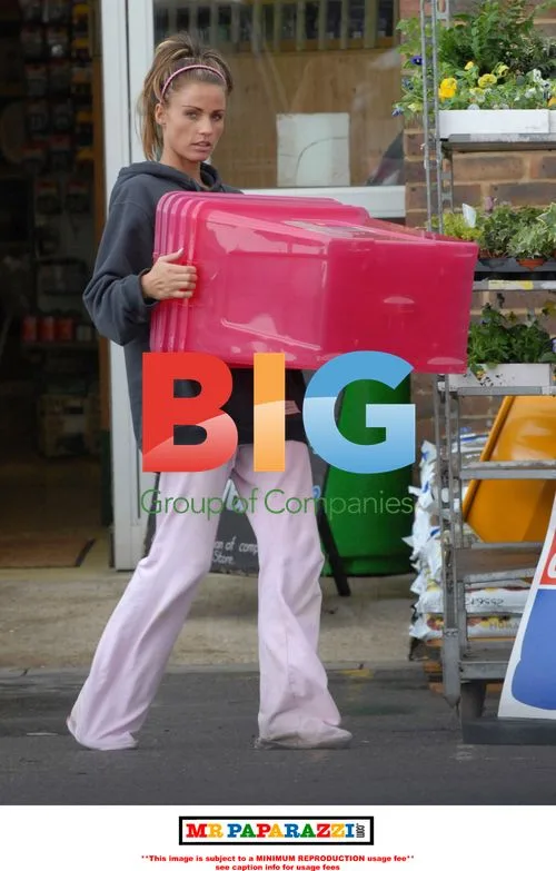 Katie Price carries pink box