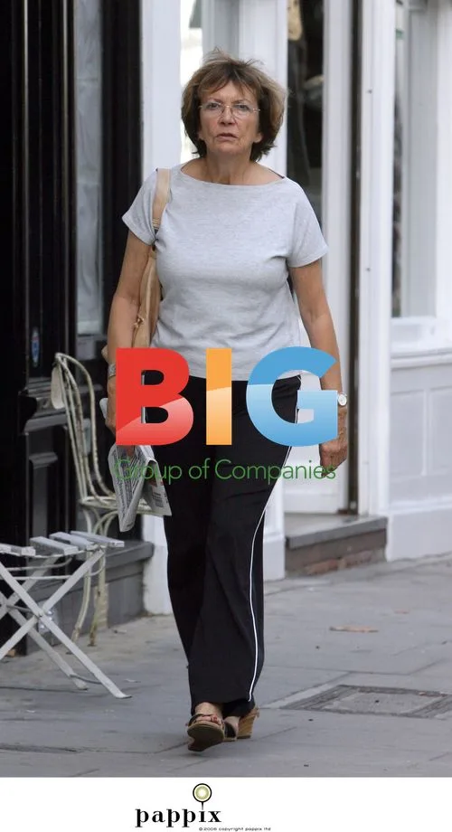 Joan Bakewell doesn't look happy buying newspaper in London