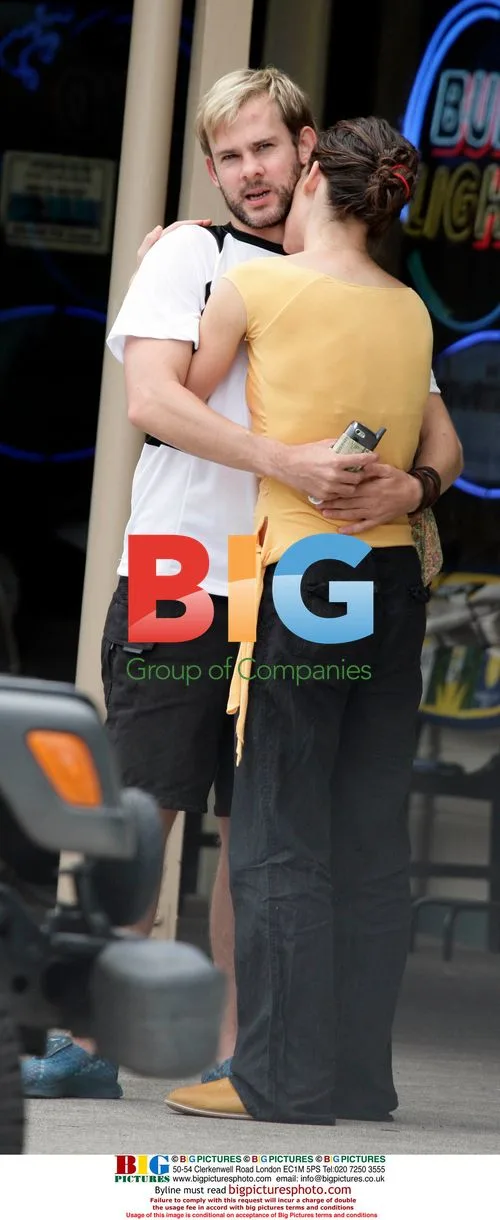 Evangeline Lilly and Dominic Monaghan kiss and hug