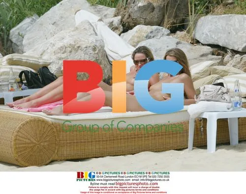 Mrs Robinson band members sunbathe on beach