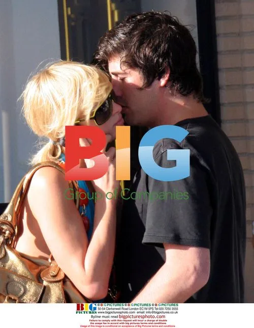 Paris Hilton and Brandon Davis kiss outside Barney's