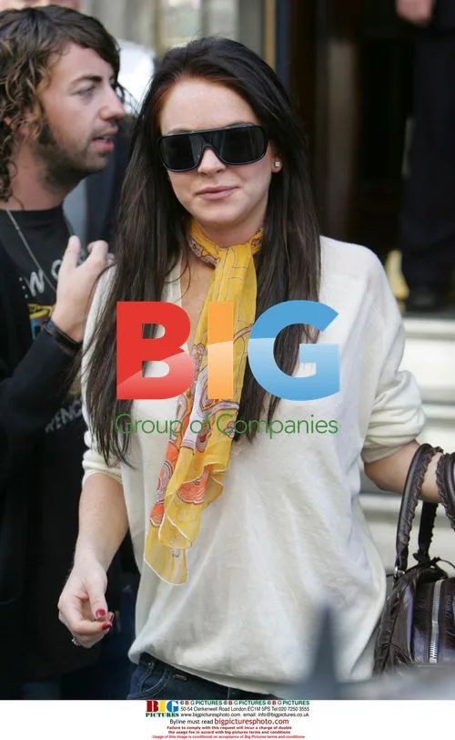 Lindsay Lohan leaves Ritz hotel with boyfriend