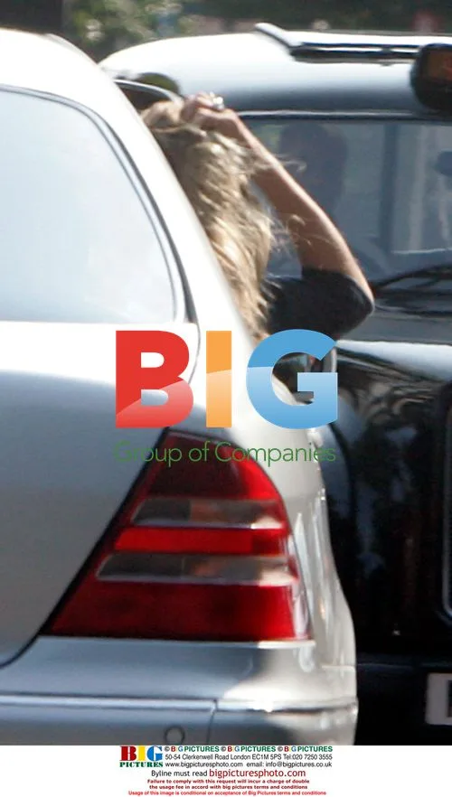 Kate Moss hangs out of car to dry her hair