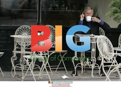 Chris Tarrant chats on phone at cafe