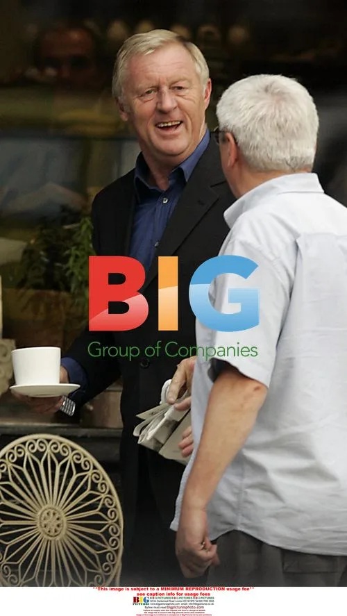 Chris Tarrant drinks coffee outside cafe