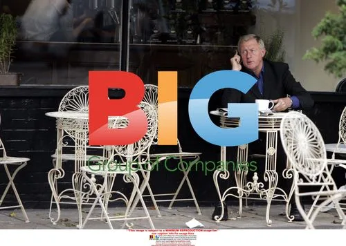 Chris Tarrant chats on phone outside cafe
