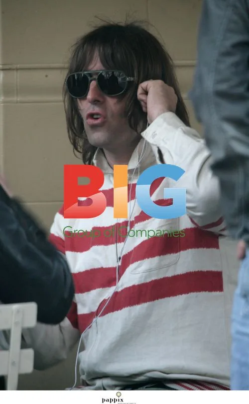 Liam Gallagher relaxing with brother Paul in London