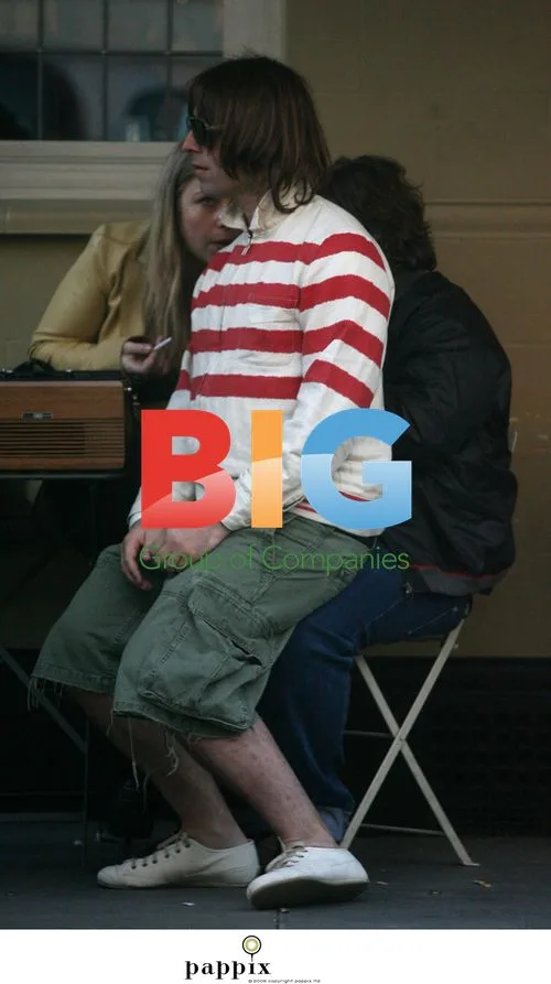 Liam Gallagher chills with brother Paul outside London pub
