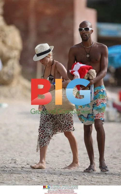Sienna Miller Relaxing on Beach in Spain