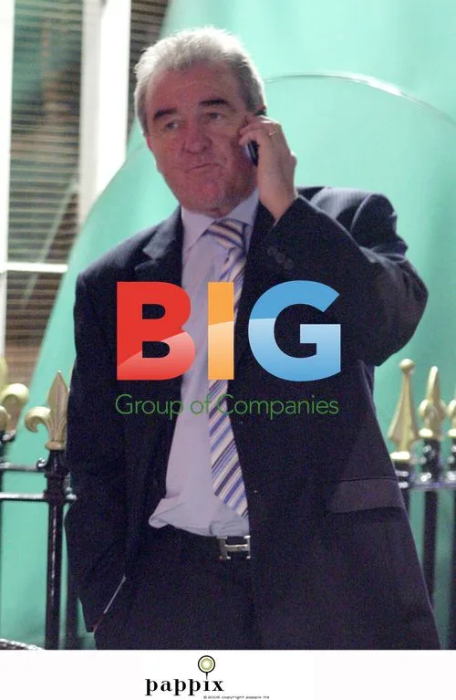 Terry Venables makes faces on mobile in London