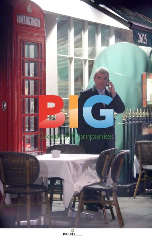 Terry Venables chats on mobile in London