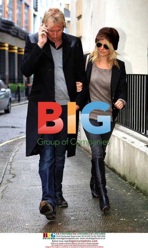 Sienna Miller and Rhys Ifans stroll arm in arm in London