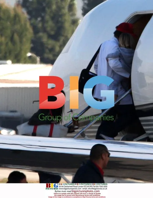 Jennifer Aniston and mystery man board private jet