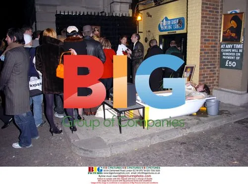 Man in Bathtub Outside Bowling Alley