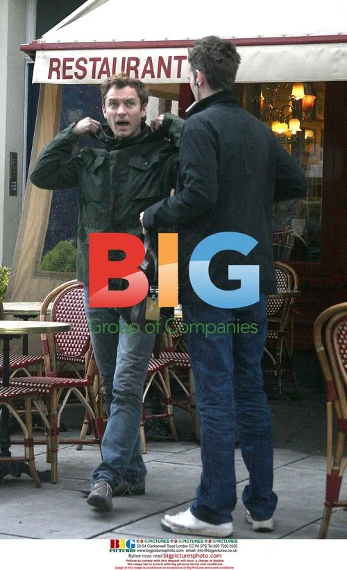 Jude Law chatting with friends in London