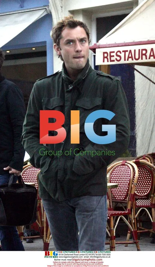 Jude Law Chats with Friends in London