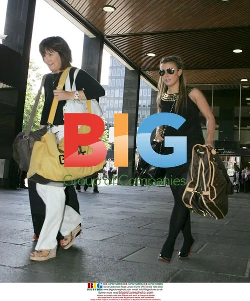 Coleen Mcloughlin with luggage at Euston Station