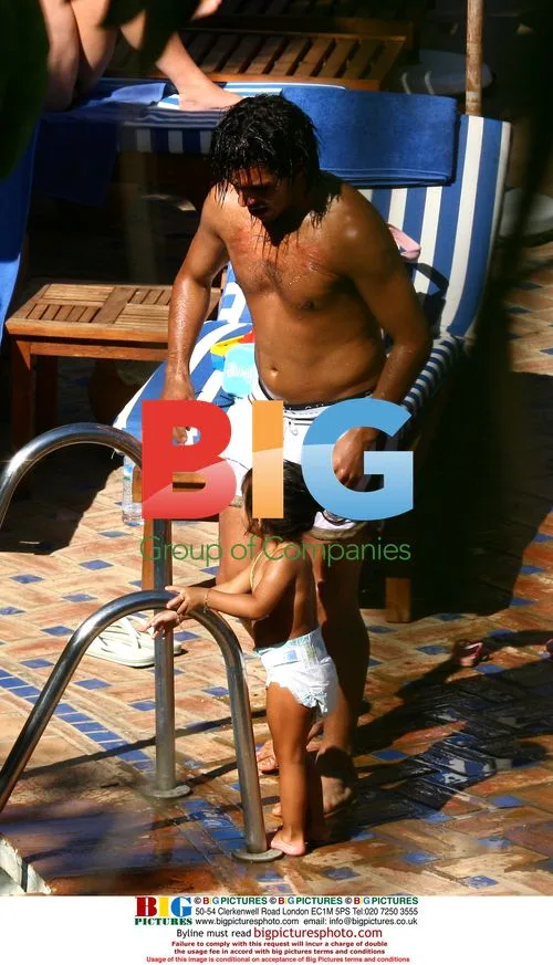 Carlos Tevez on holiday with girlfriend and daughter