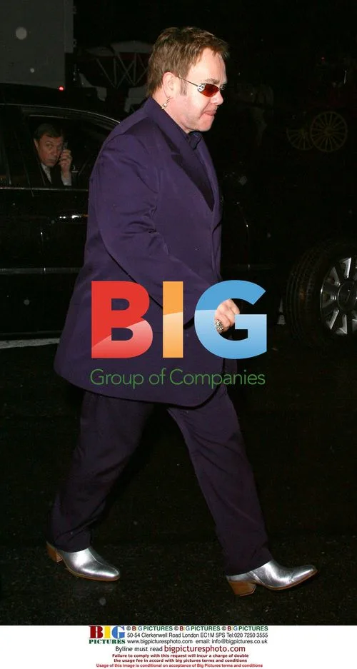 Elton John Leaves Midtown Hotel in Silver Shoes