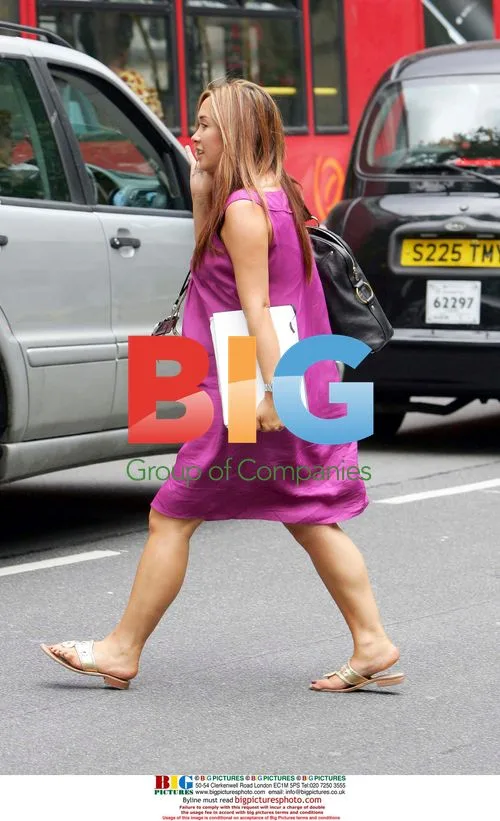 Pregnant Myleen Klass chatting on mobile