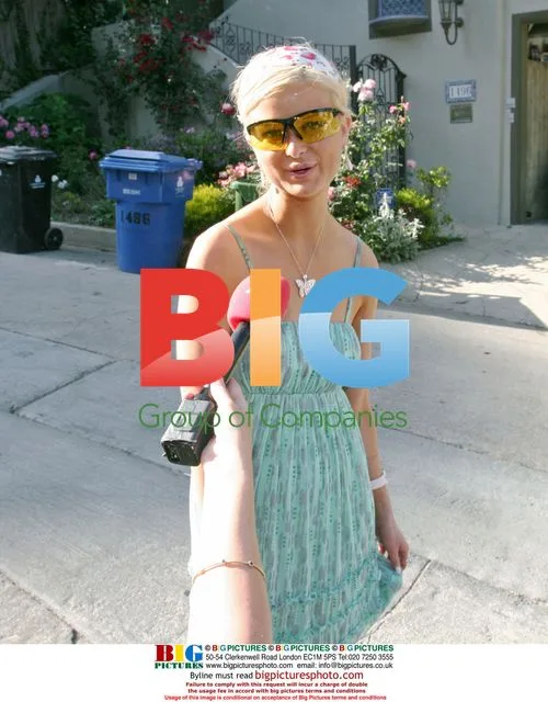 Paris Hilton Look-A-Like Carries AK-47 Outside Home