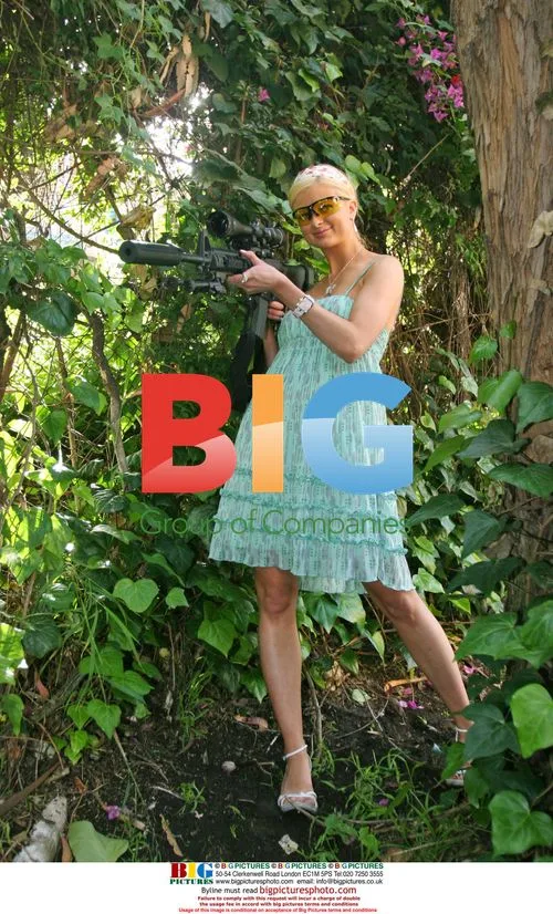 Paris Hilton Look-a-like Natalie Reid with AK-47