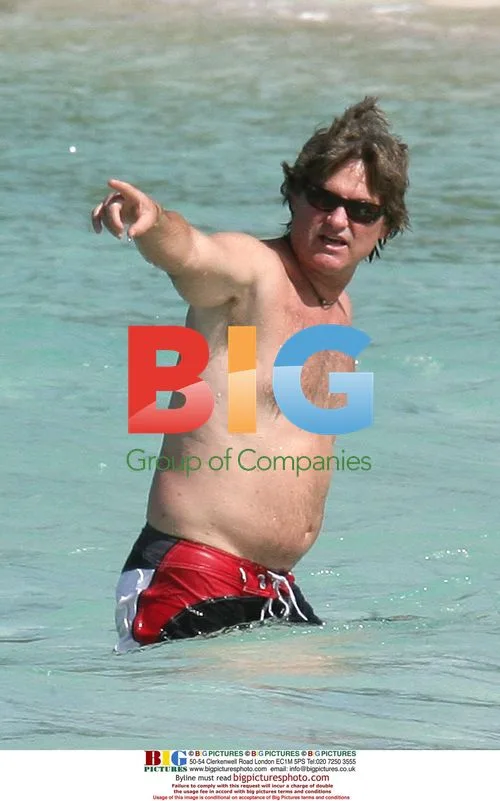 Kurt Russell swims, Goldie Hawn on beach