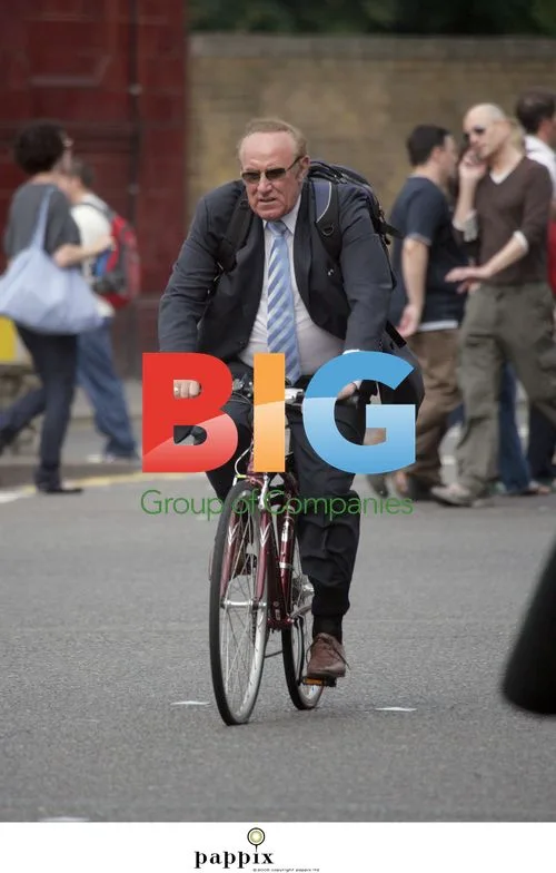 Andrew Neil rides bike without helmet