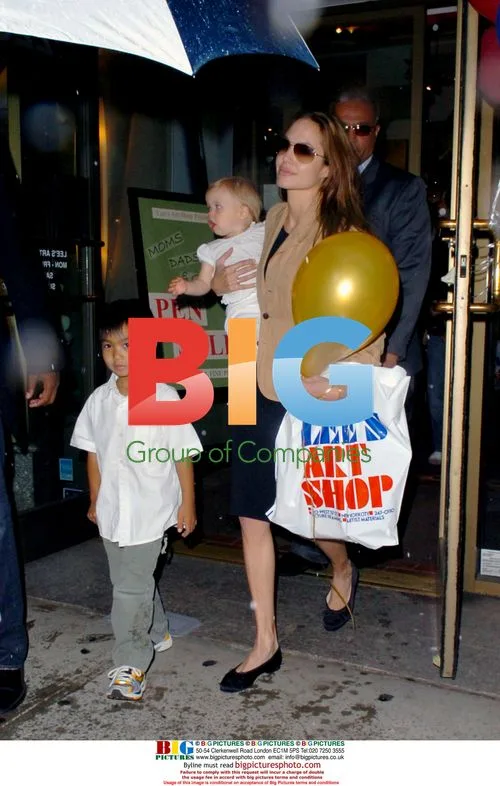 Angelina Jolie with Kids Exit Shop in Rain