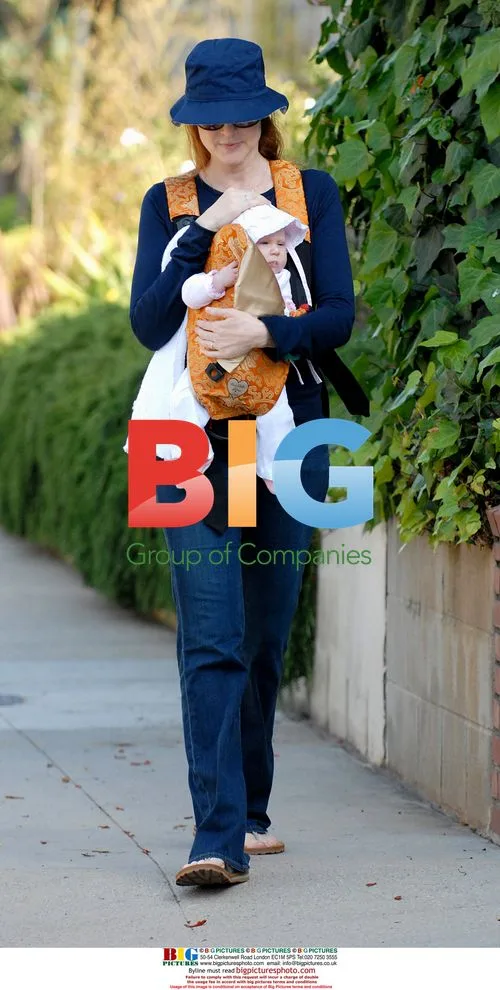 Marcia Cross cradles sleeping twin