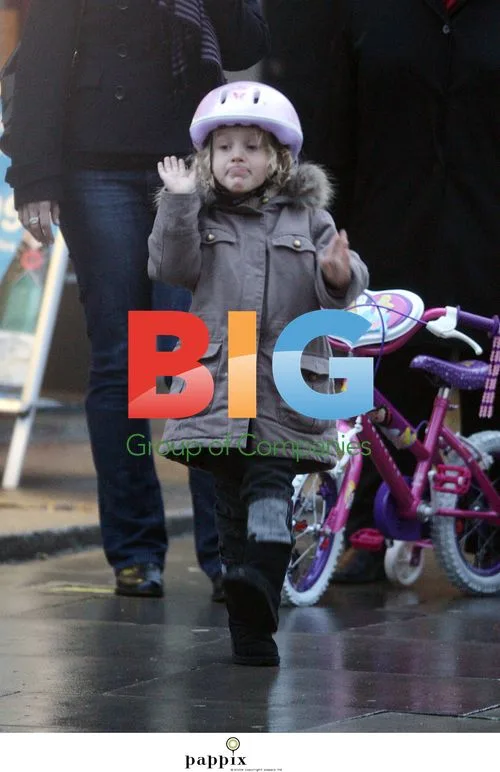 Misty Kyd rides bike in rainy North London