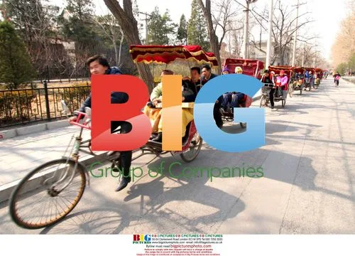 Tourists Exploring Beijing Hutongs by Rickshaw
