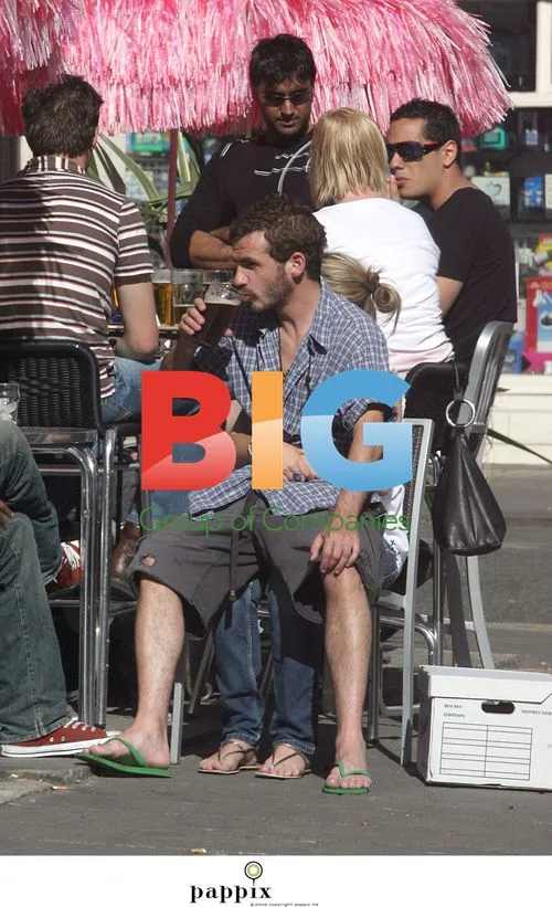 Kieran O'Brien Sitting on Girl's Lap Outdoors