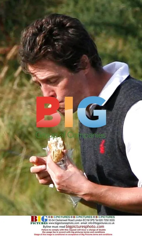 Hugh Grant Eats Sandwich While Golfing