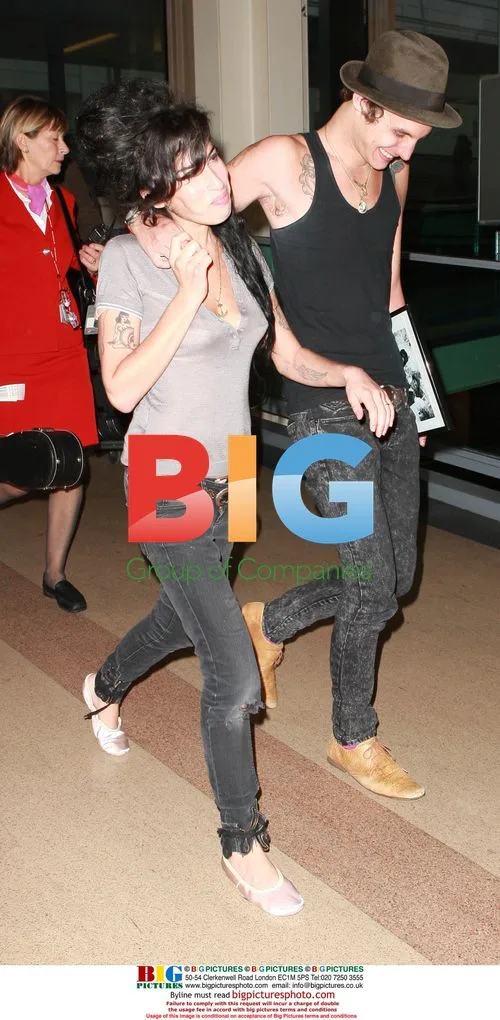 Amy Winehouse and Blake Fielder-Civil Arrive at Gatwick
