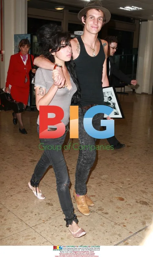 Amy Winehouse and Blake Fielder-Civil Arrive at Gatwick