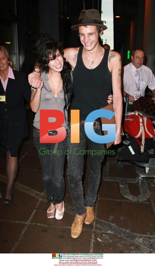 Amy Winehouse and Blake Fielder-Civil Arrive at Gatwick