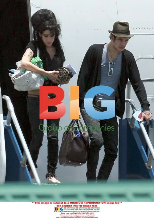 Amy Winehouse and husband arrive at holiday