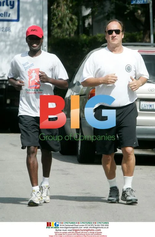 Actor Jim Belushi Jogging with Trainer