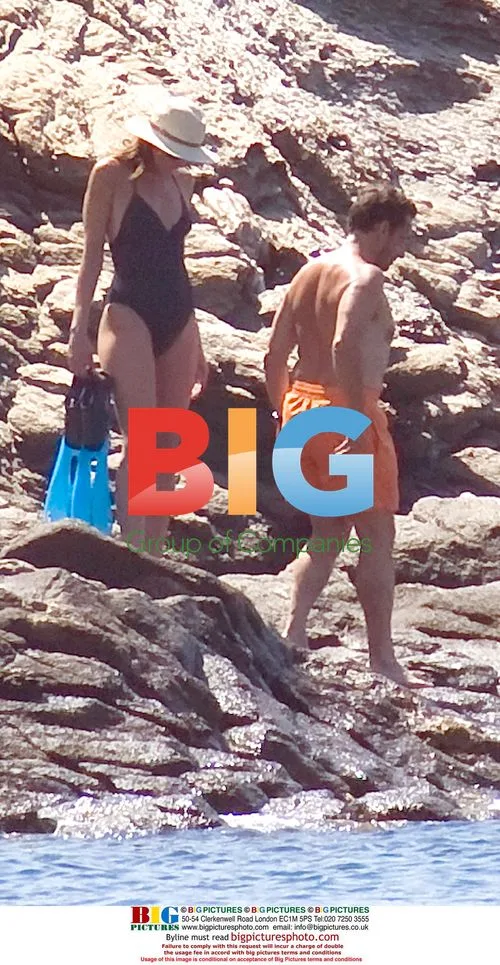 Nicolas and Carla Sarkozy go for a swim