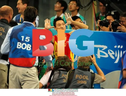Chinese gymnast Yang Wei surrounded by photographers