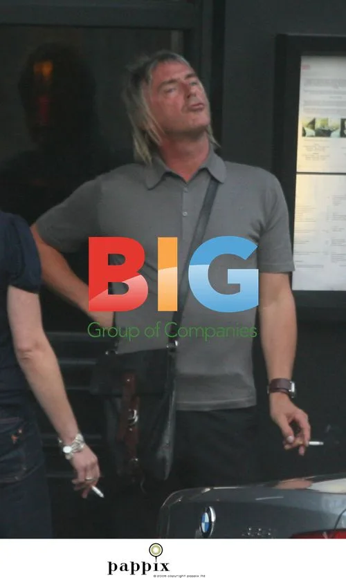 Paul Weller Takes Cigarette Break in Pub