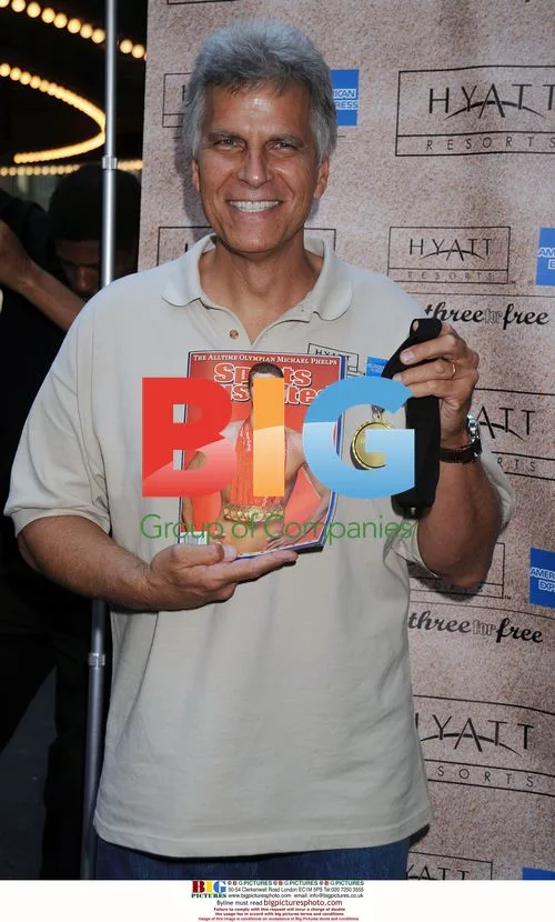 Mark Spitz holds up Sports Illustrated cover