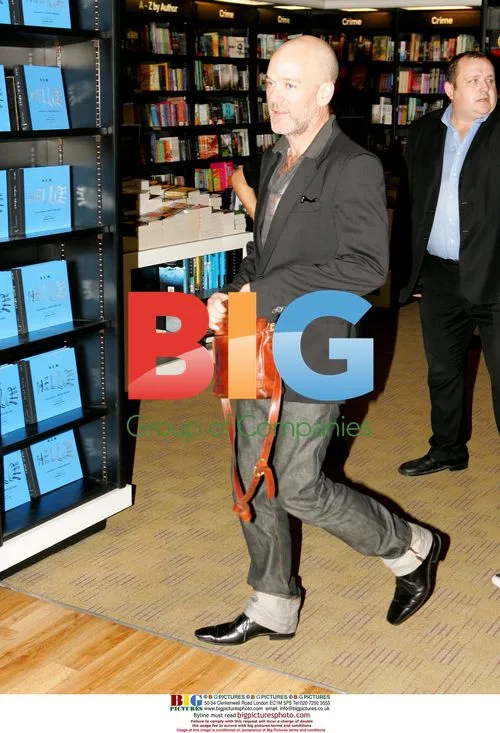 R.E.M. members sign photo book