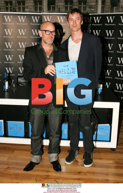 R.E.M. musicians sign photo book