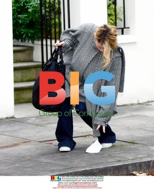 Billie Piper and Laurence Fox walk with baby