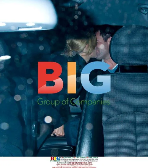 Gaby Logan and Kenny Logan kiss in cab